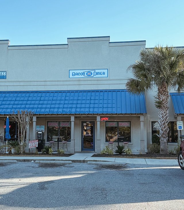 Bacon Diner in Bluffton — the blue metal roof, OPEN in neon and BREAKFAST and LUNCH lettered on the windows