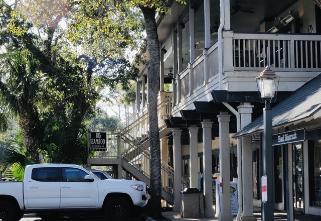 Big Bamboo at Coligny — the two-story building with its hanging sign, galleries above and the Bad Biscuit storefront at street level