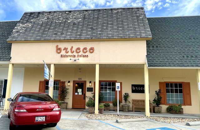 Bricco Ristorante Italiano storefront with rust script sign, shutters and potted plants, Bluffton SC