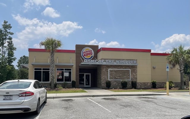Burger King on Okatie Highway in Okatie — the round logo over HOME OF THE WHOPPER, a palmetto and a white Ford in the lot