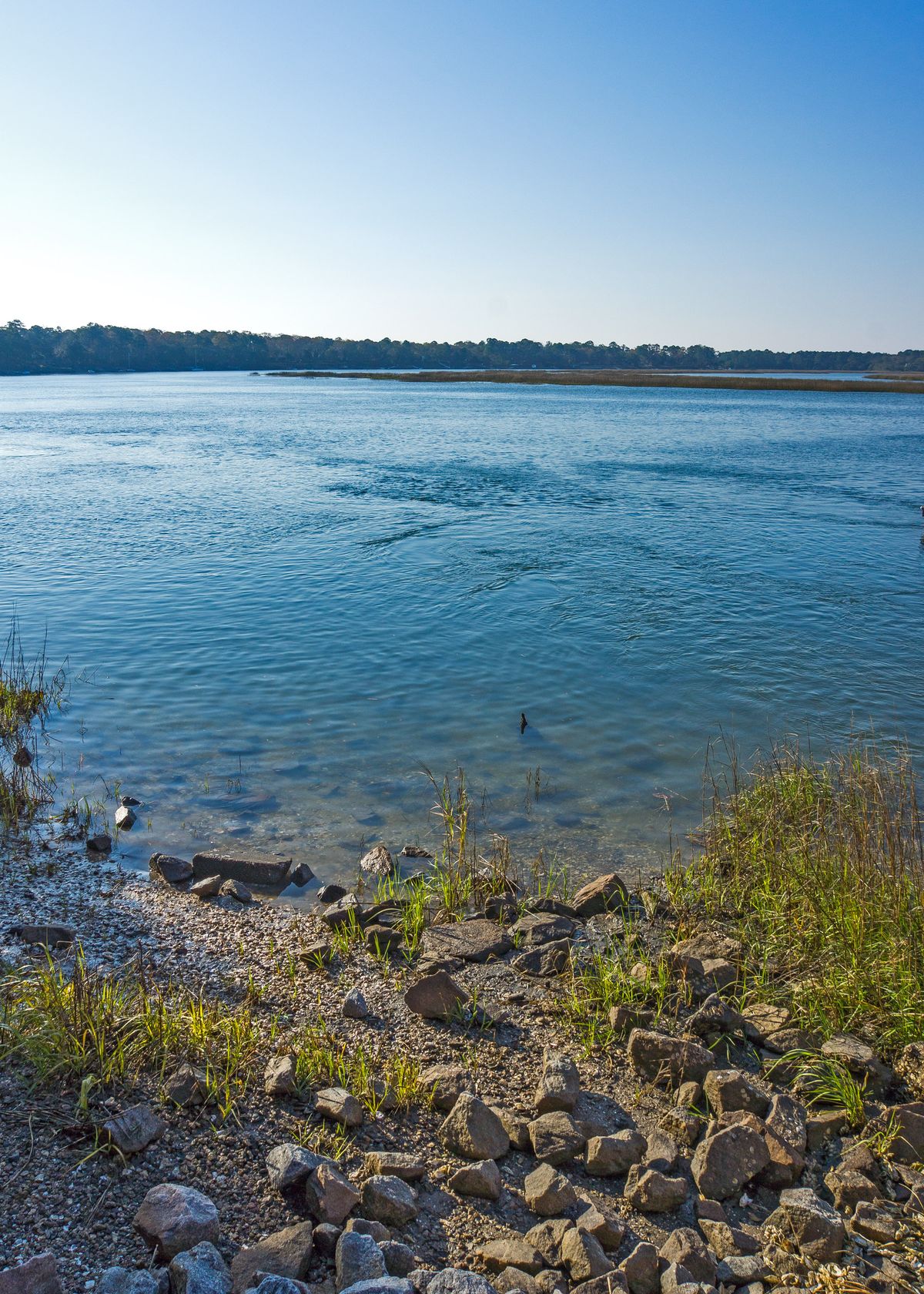 The May River seen from the rocky shore at the foot of Calhoun Street in Bluffton