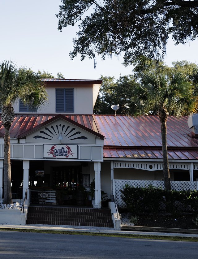 Carolina Crab Company on Palmetto Bay Road, Hilton Head Island — the crab sign under a sunburst gable, copper roof and two palmettos