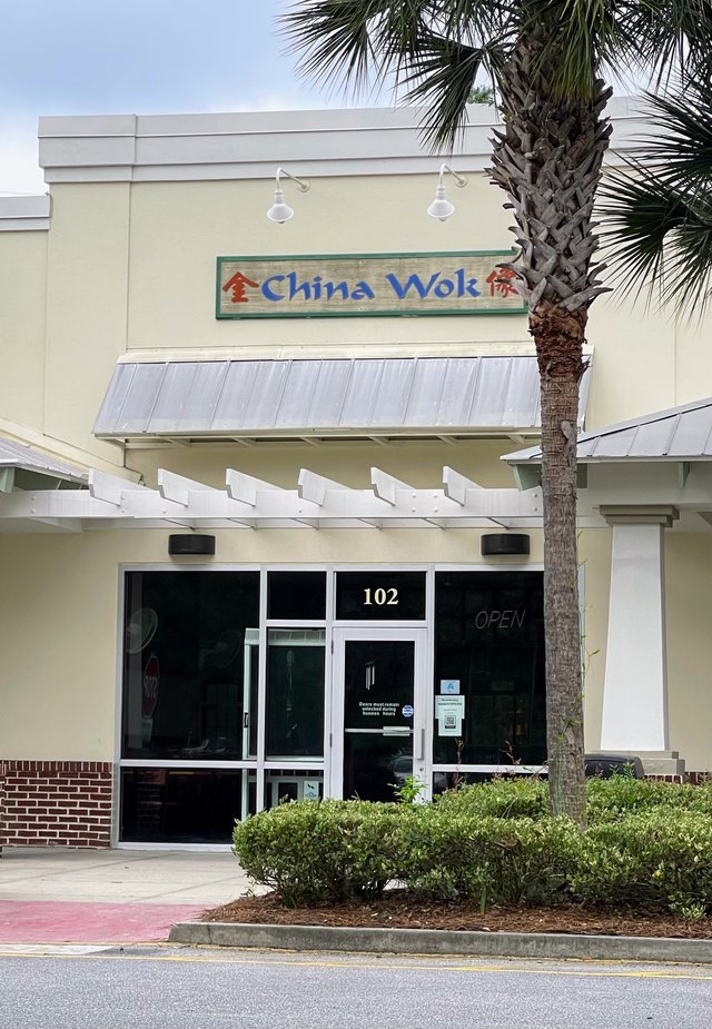 China Wok storefront with blue letters and a palmetto out front, north Bluffton SC