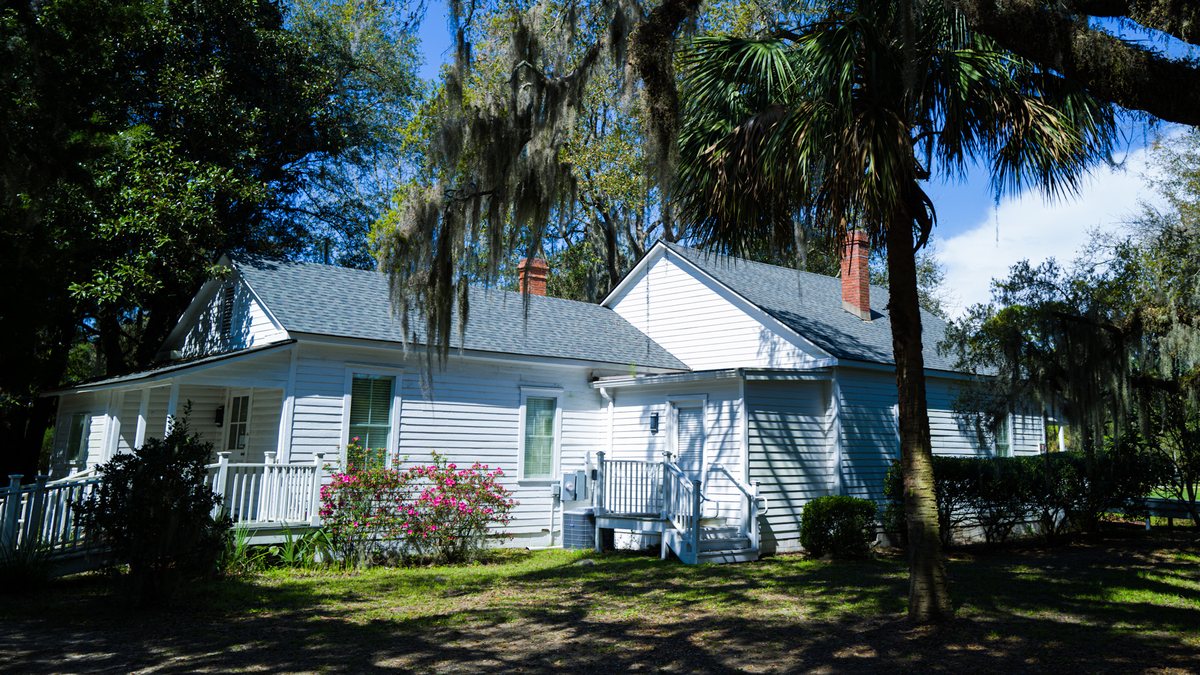 The front of the house. Discovery House from the lawn, oaks overhead.