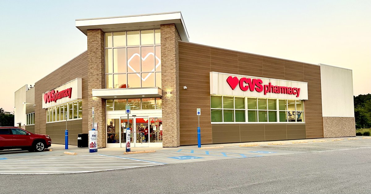 CVS Pharmacy on US 278 in Hardeeville — the red heart signs, stone pillars and a glowing heart in the front glass at dusk