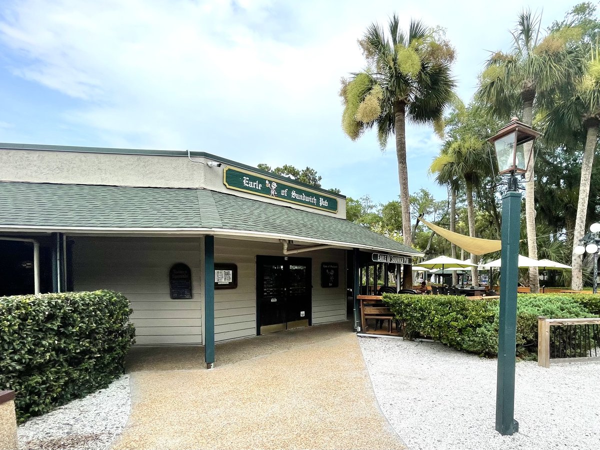 Earle of Sandwich Pub with green sign, patio umbrellas and palmettos, Coligny area, Hilton Head Island SC