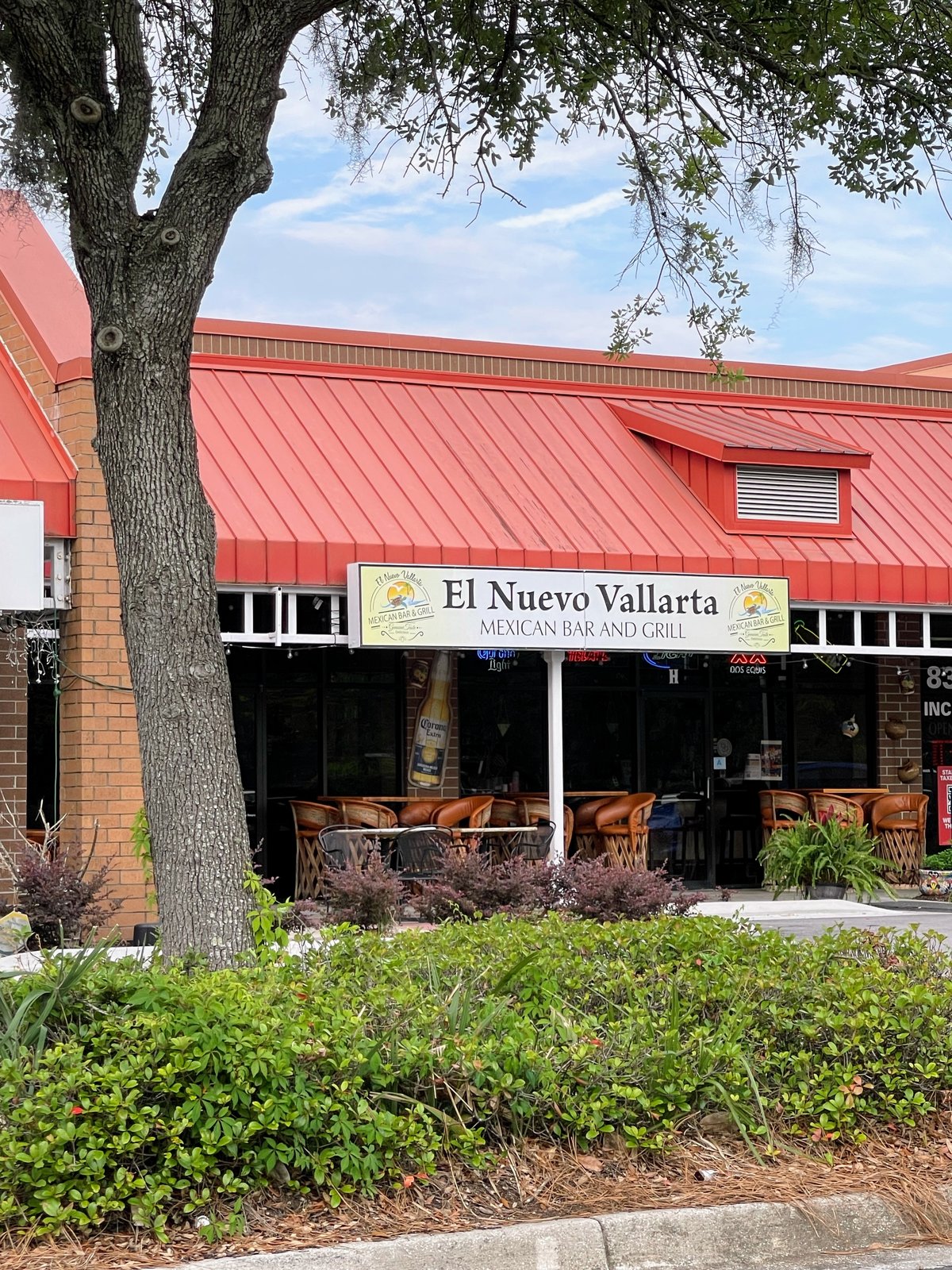 El Nuevo Vallarta Mexican Bar and Grill in Bluffton — the sign over patio tables under a red metal roof