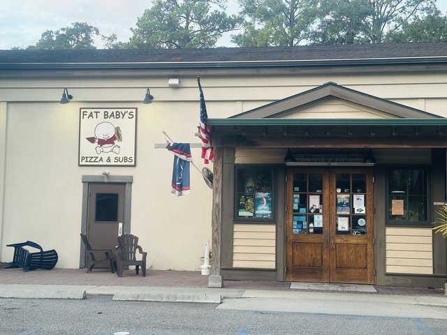 Fat Baby’s Pizza & Subs on Hilton Head Island — the baby-mascot sign and wooden double doors