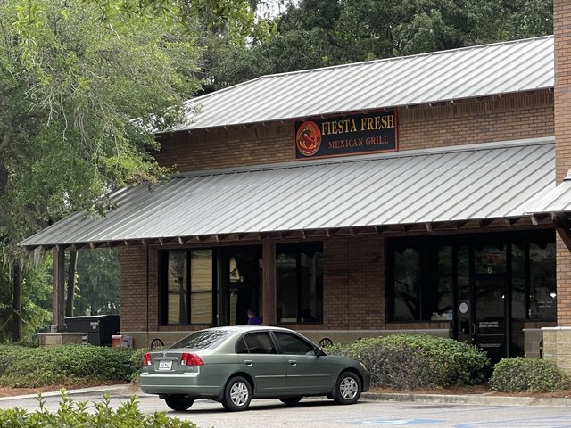Fiesta Fresh Mexican Grill storefront with chili-pepper sign under moss-draped oaks, Bluffton SC