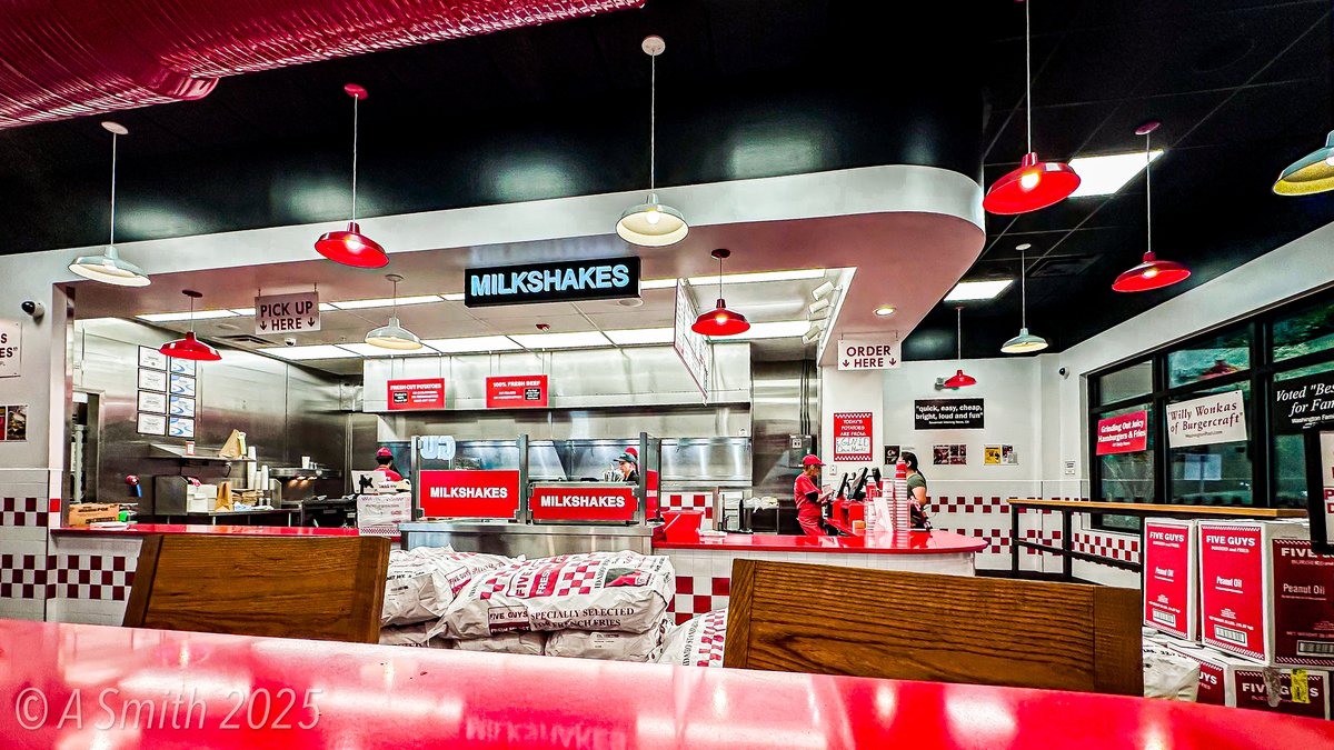 Five Guys interior with milkshake counter, red pendant lights and potato sacks, Bluffton SC