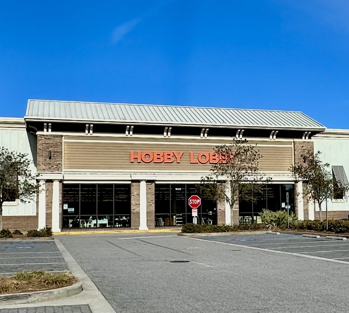 Hobby Lobby in Bluffton — big orange letters over the glass front, a stop sign in the drive and an empty Sunday-morning lot