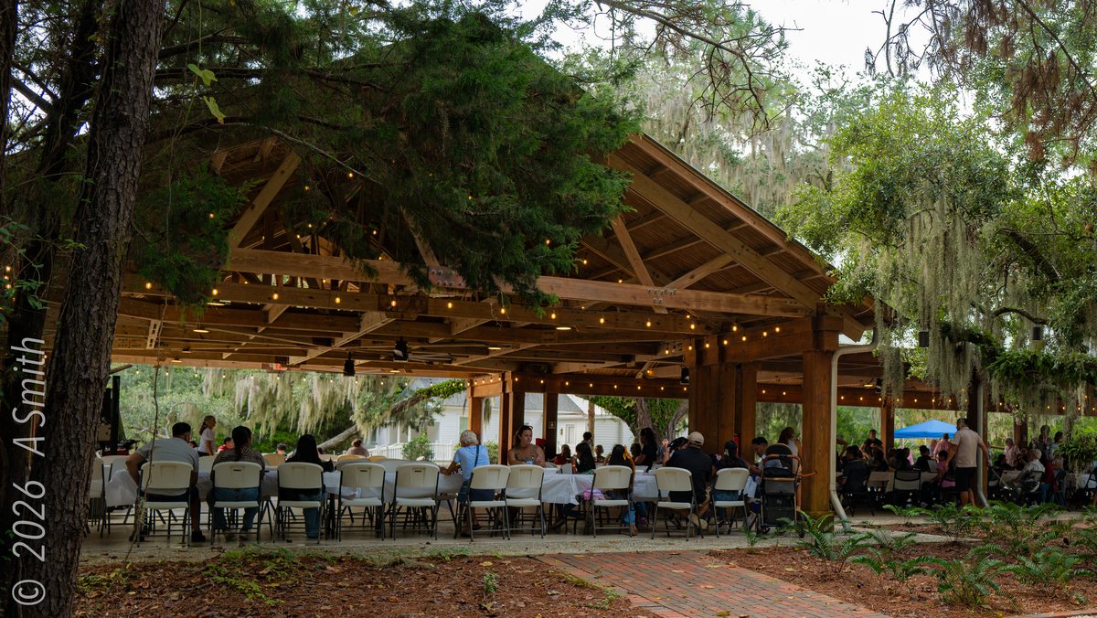 Dinner under the pavilion. Long tables set for an evening event in the pavilion.