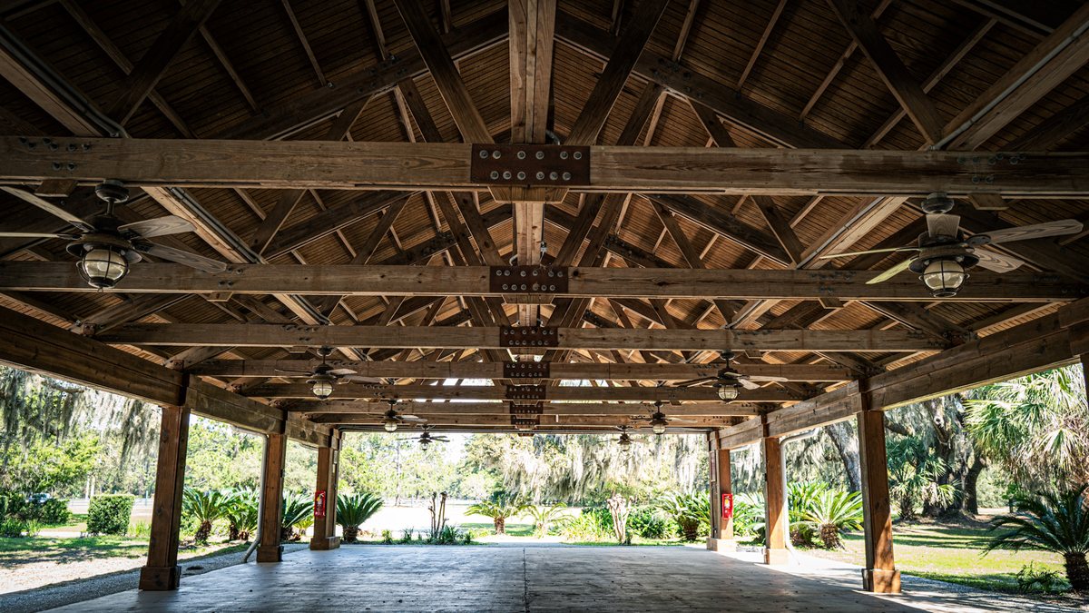 Under the pavilion. Inside the Mary Ann Peeples Pavilion — timber trusses, ceiling fans and room for a crowd.