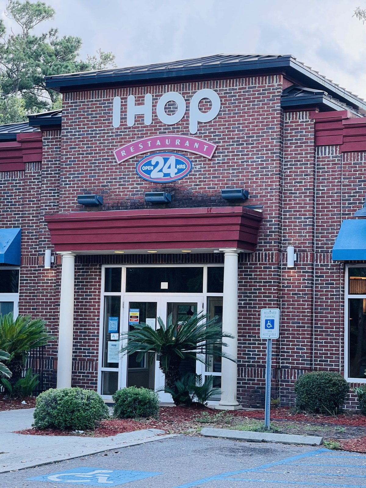 The IHOP front doors up close — glass doors, the open sign, and menu boards