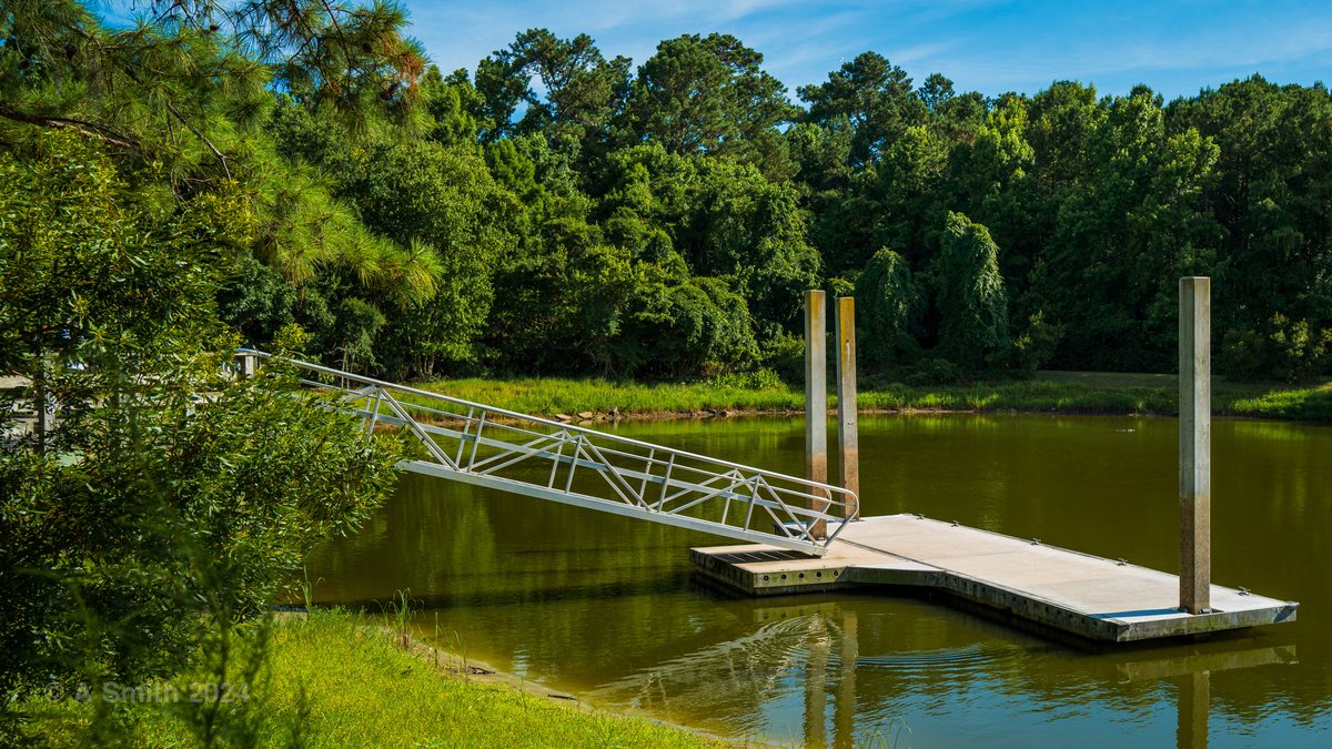 The floating dock. The gangway and floating dock reaching into the lake.
