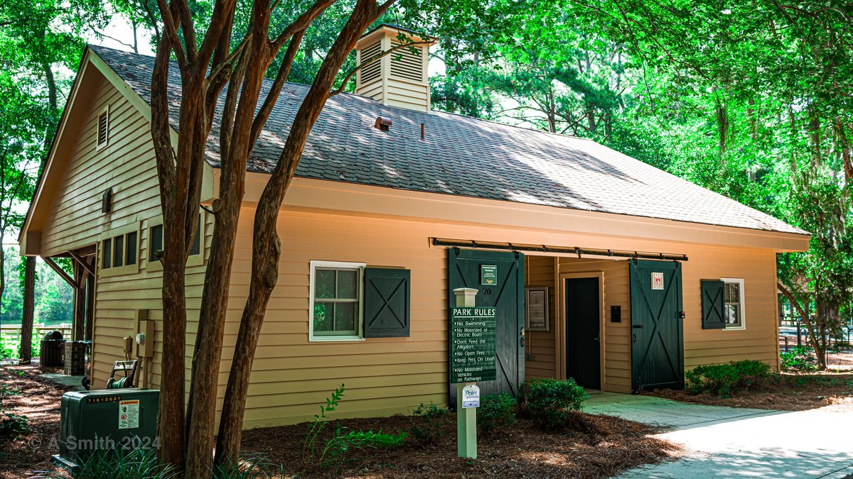 The park building. A tan-sided park building under the pines by the loop.