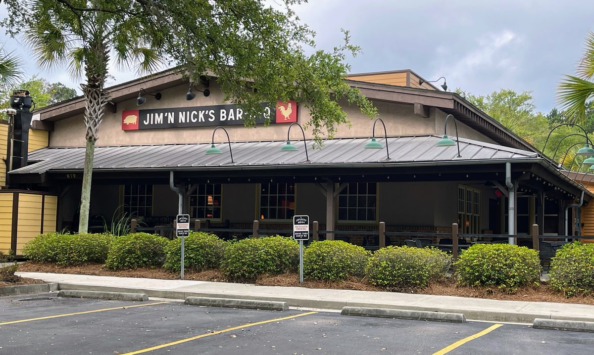 Jim 'N Nick's Bar-B-Q storefront with pig and rooster sign over a covered porch, Bluffton SC