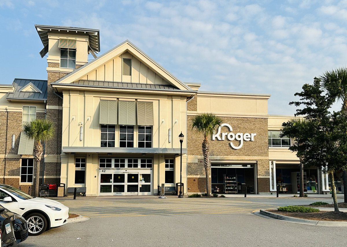Kroger at Shelter Cove on Hilton Head Island — the gabled entrance, palmettos and a white Tesla in the lot