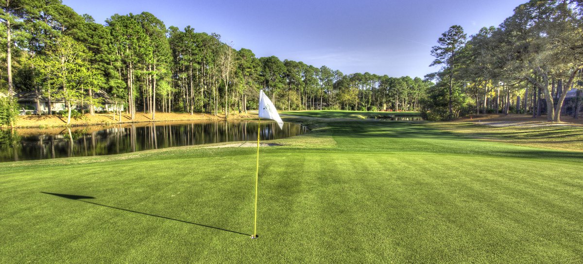 North Course, Hole 3. The 3rd green sits right on the water — flag in, lake behind.