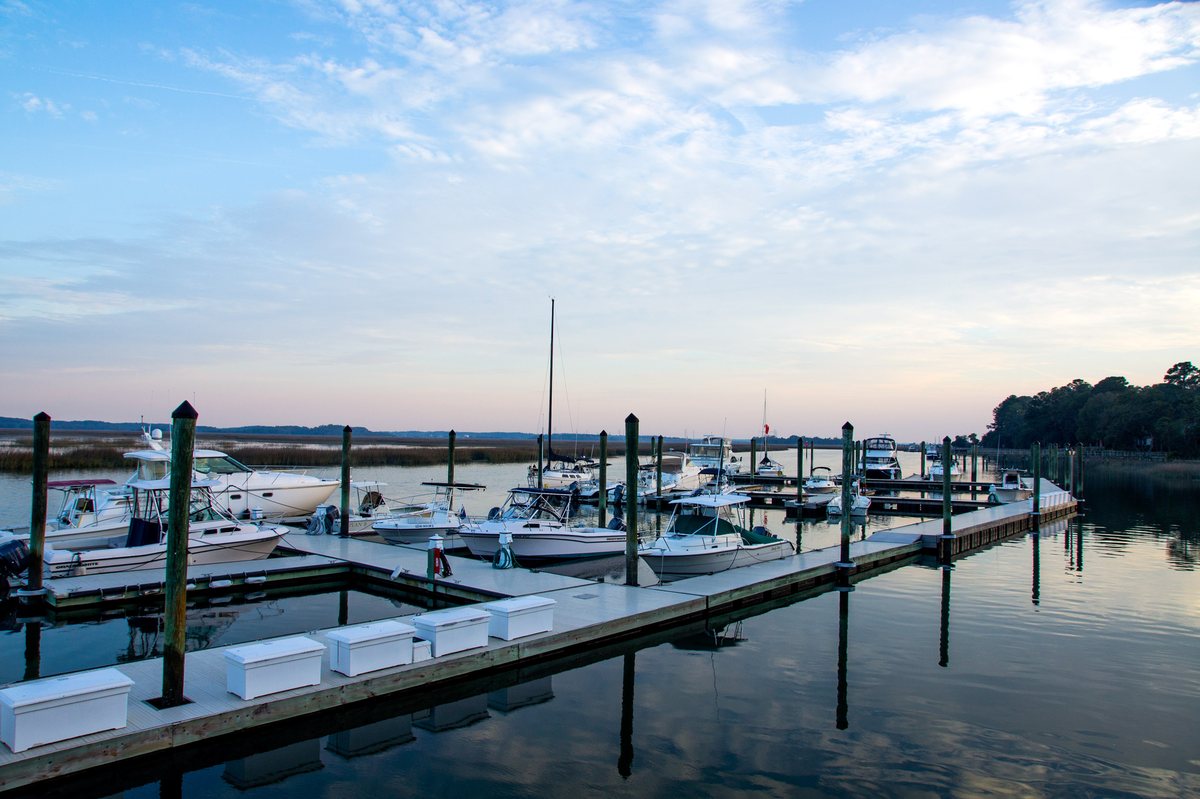 Moss Creek Marina. The marina at dusk — docks, boats, and glassy water.