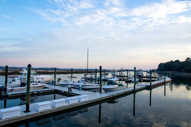 Moss Creek Marina. The marina at dusk — docks, boats, and glassy water.