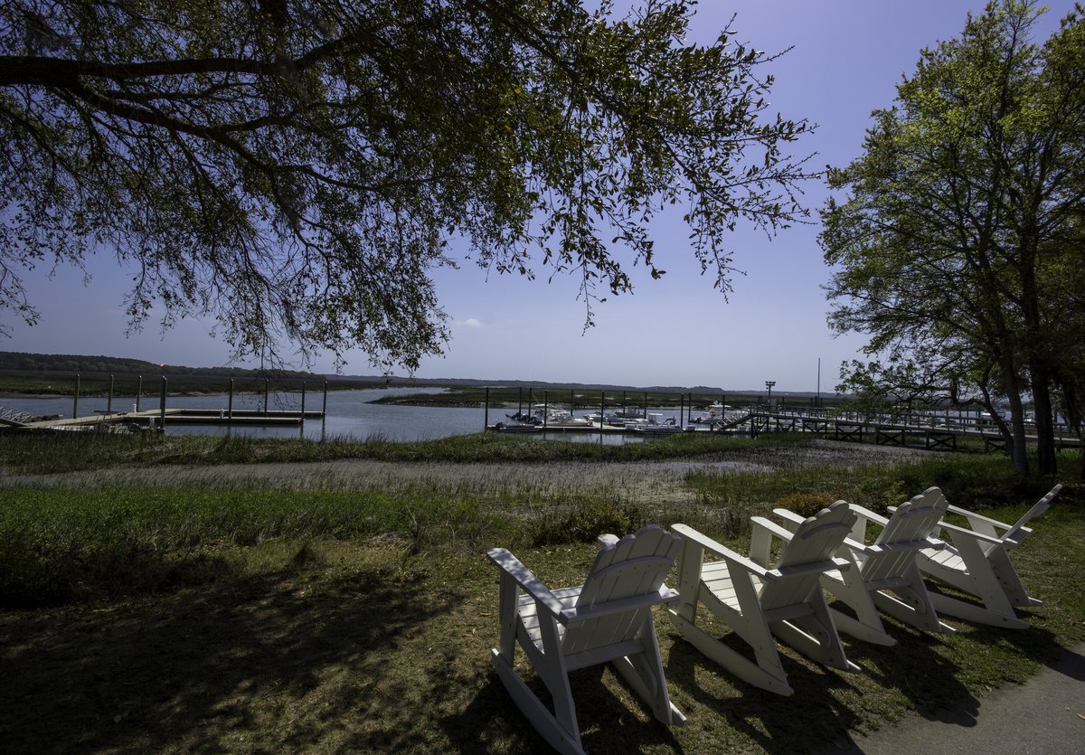 Marina view. The same four chairs, the marina spread out below them.