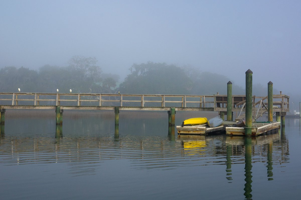 Kayaks in the fog. Kayaks wait out a foggy morning at the dock.
