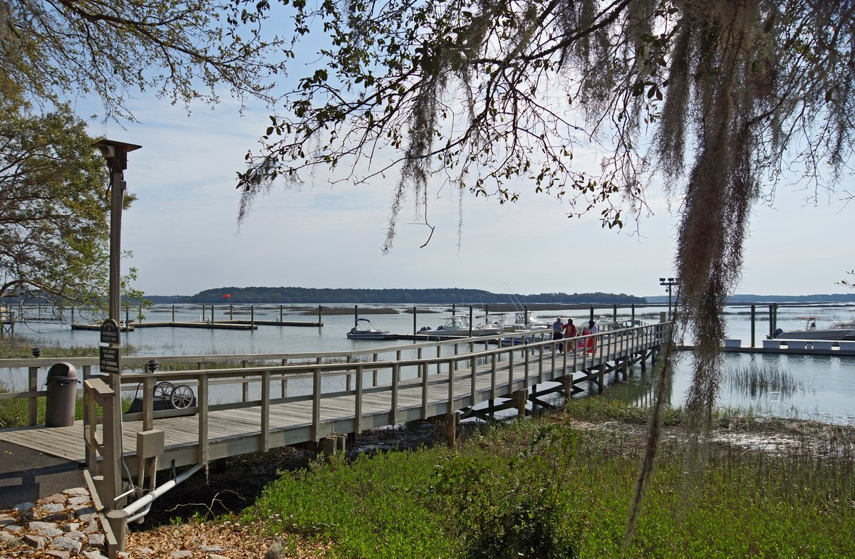 Down to the docks. The boardwalk runs from the shore pines down to the marina.