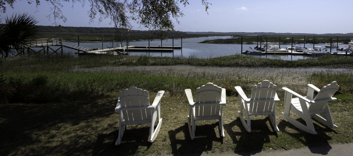 The chairs. Four Adirondack chairs above the marina — the best seats in Moss Creek at golden hour.