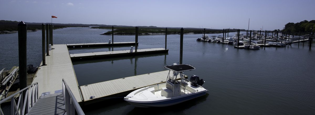 The docks. The marina's docks reach into the creek, one center-console tied up close.
