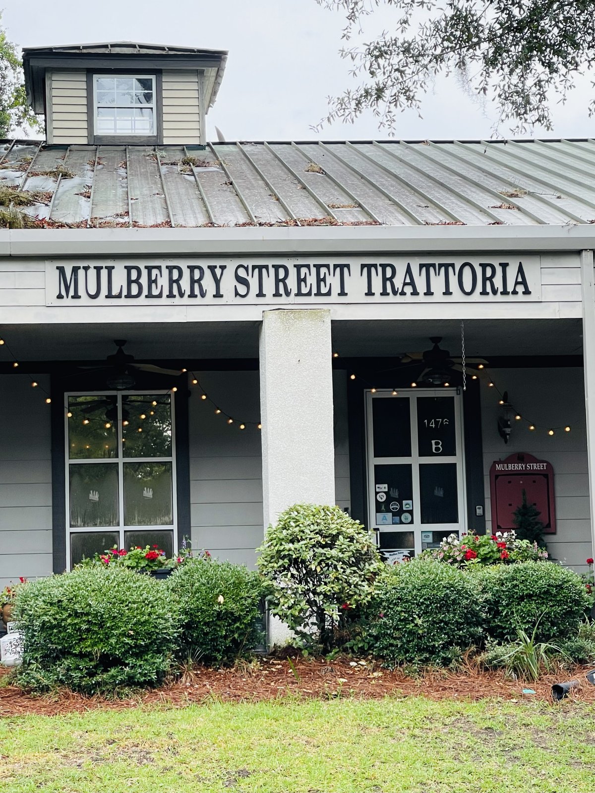 Mulberry Street Trattoria storefront with covered porch, string lights and flower boxes, Bluffton SC