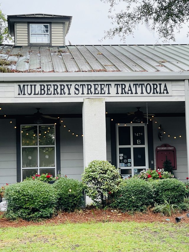 Mulberry Street Trattoria storefront with covered porch, string lights and flower boxes, Bluffton SC