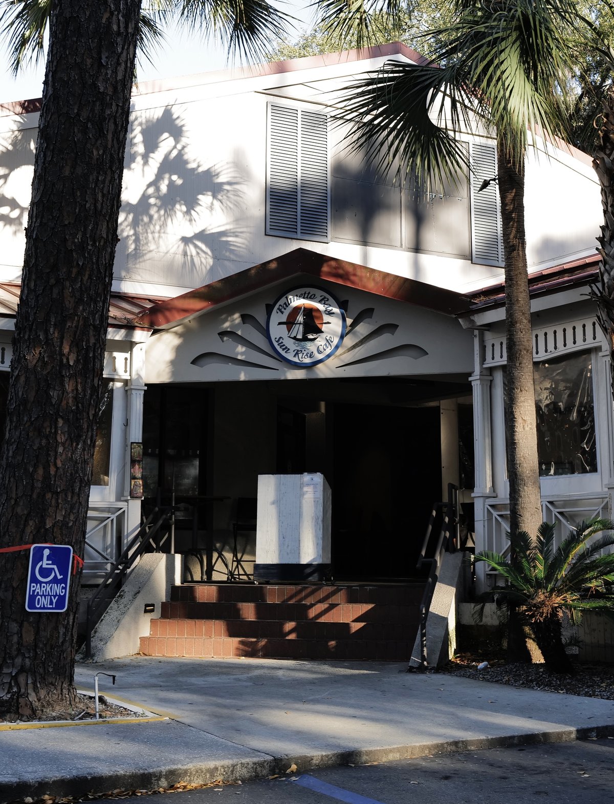 Palmetto Bay Sunrise Cafe on Hilton Head Island — the round sailboat sign over the porch, brick steps and palms