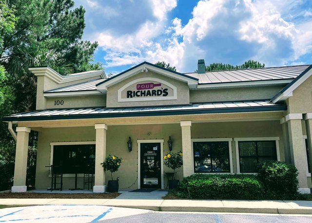 Pour Richard's in Bluffton — the wine bar under a metal roof, columns across the porch and lemon trees by the door