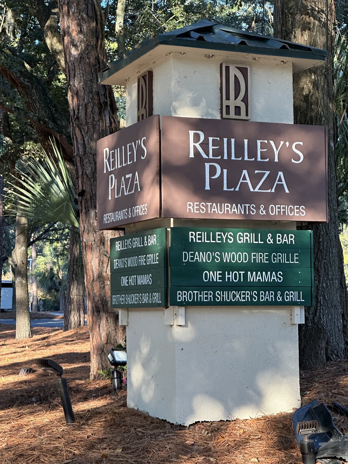 The Reilley's Plaza monument sign on Hilton Head Island — restaurants and offices, listing Reilley's Grill, Deano's, One Hot Mamas and Brother Shucker's