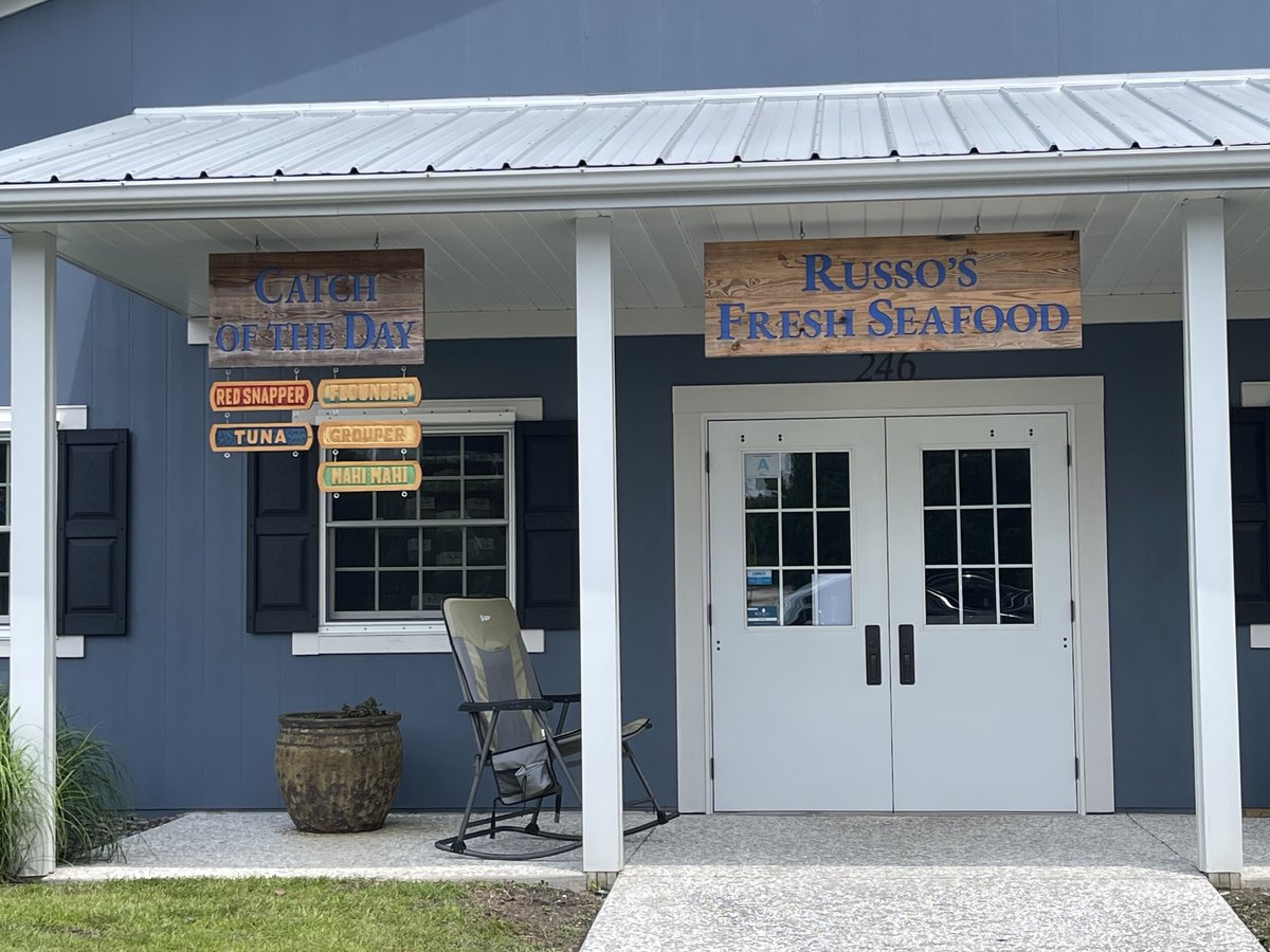 Russo's Fresh Seafood in Bluffton — the wooden sign over white double doors, the Catch of the Day board and a rocking chair on the porch