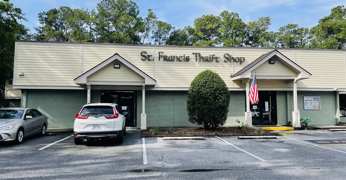 St. Francis Thrift Shop long low building with script sign and American flag, Hilton Head Island SC