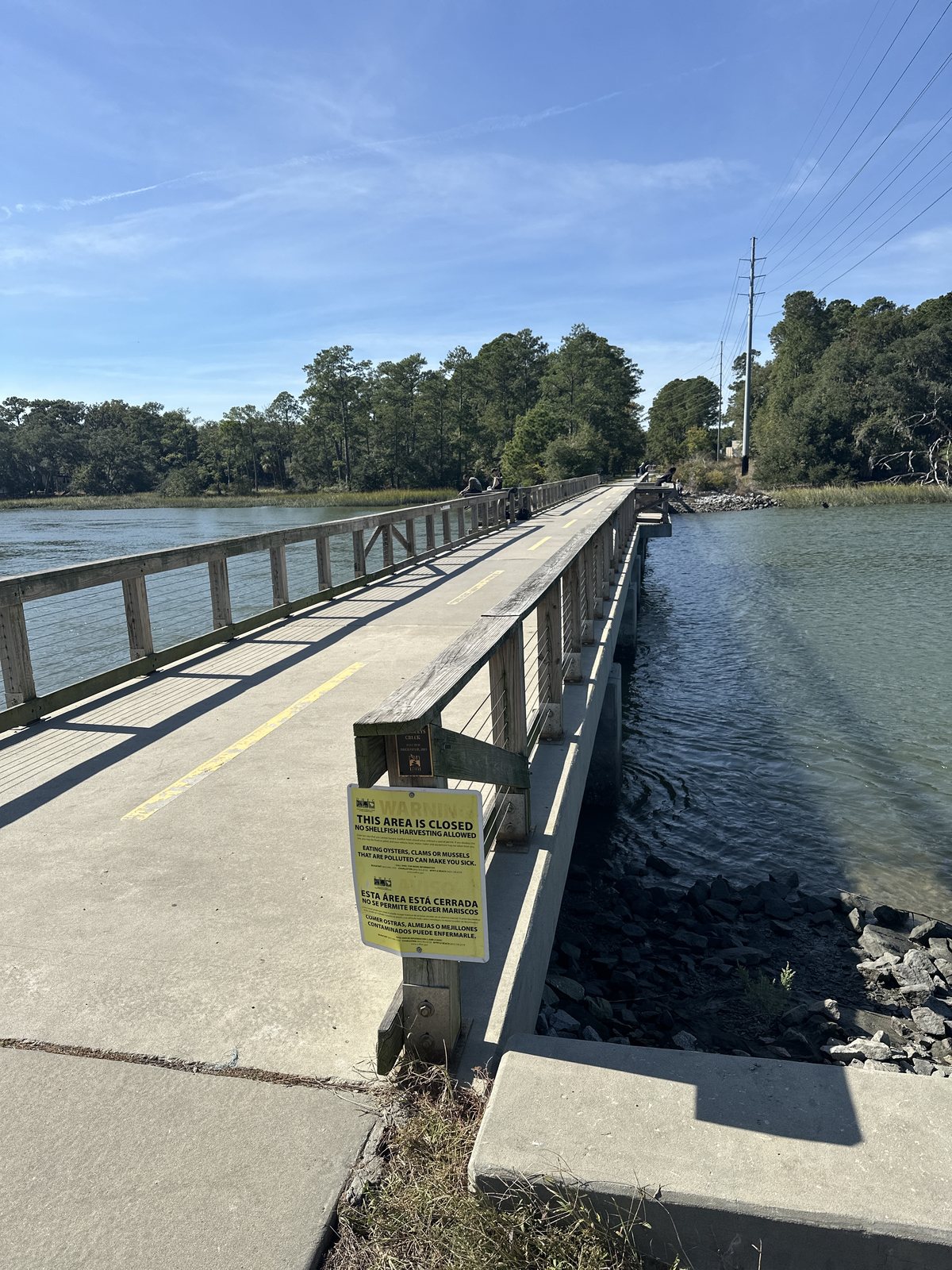 The fishing pier. The full length of the pier over the creek — its far end posted closed the day this was shot.