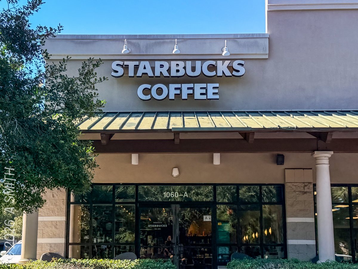 The Starbucks front entrance in October 2026 — the sign and glass doors at 1060-A