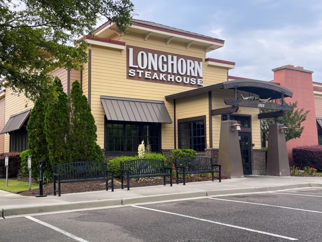 LongHorn Steakhouse restaurant front with benches and parking at Tanger Outlets 1 in Bluffton