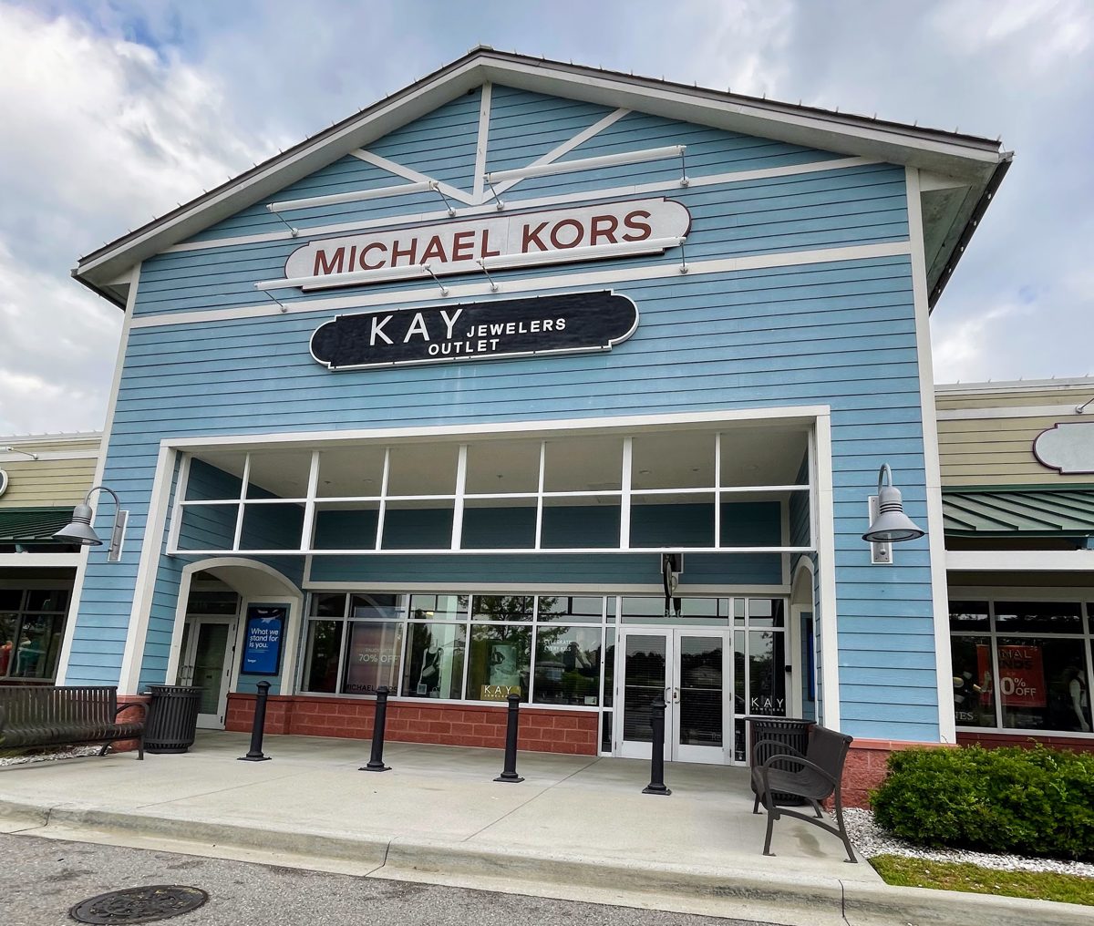 Michael Kors and Kay Jewelers Outlet signs on the blue tower at the Tanger Outlets 1 entrance