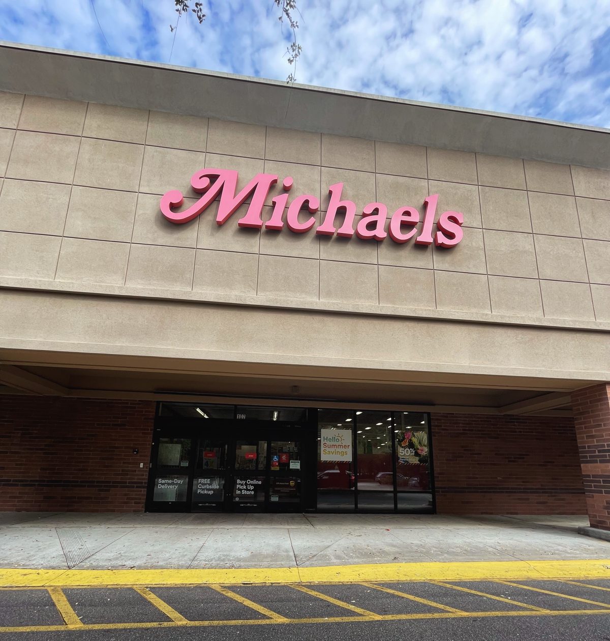 Michaels craft store near Tanger Outlets 1 — big pink script sign on a tiled facade