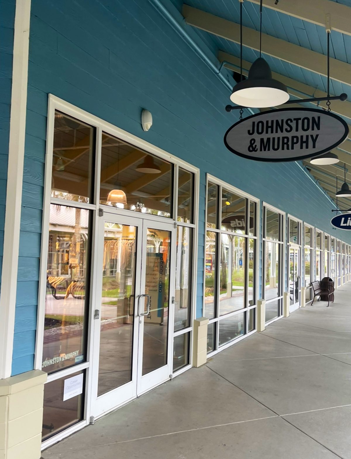 Johnston & Murphy at Tanger Outlets 2 — oval blade sign on the blue covered walkway