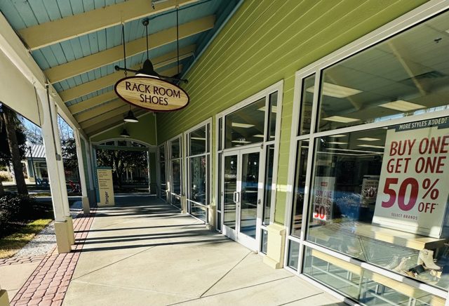 Rack Room Shoes at Tanger Outlets 2 — wooden oval sign over the covered walkway