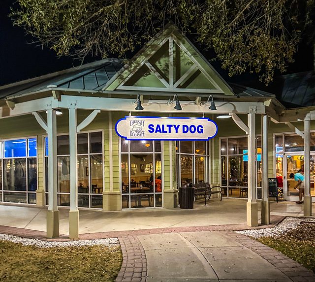 The Salty Dog restaurant at Tanger Outlets 2 lit up at night under the trees