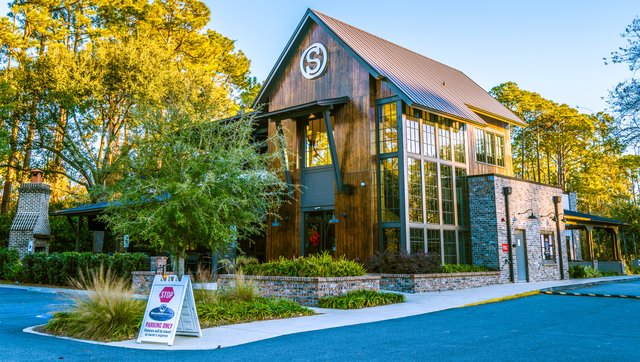 The Smokehouse on Hilton Head Island — a tall wood-and-brick building with a wall of glass