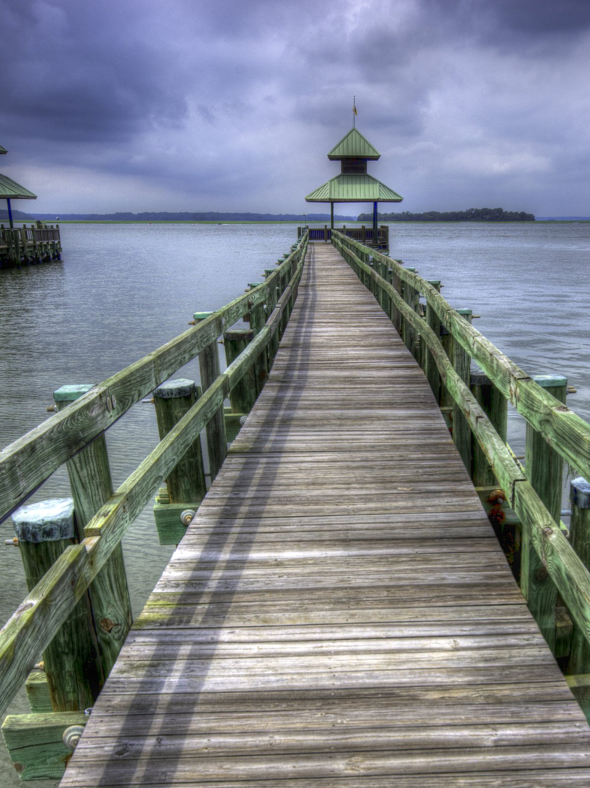 The long wooden dock at Windmill Harbour, out to a green pagoda over the water