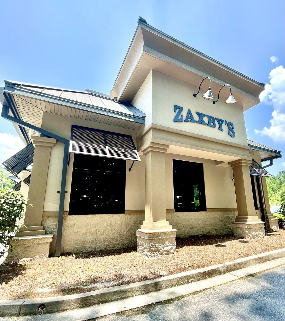 Zaxby's blue letters on a stucco and stone building, shot from the drive-thru, Okatie SC